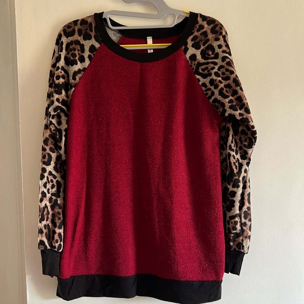 Holiday sweater with leopard sleeves